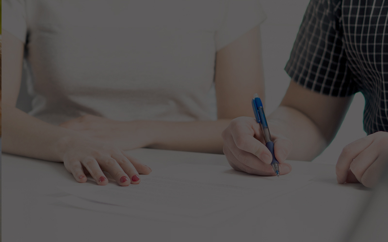 Couple signing prenuptial agreement
